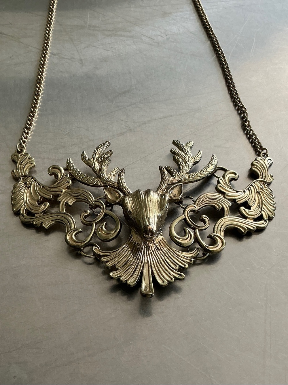 Ornate Golden Reindeer necklace, antiqued finish.